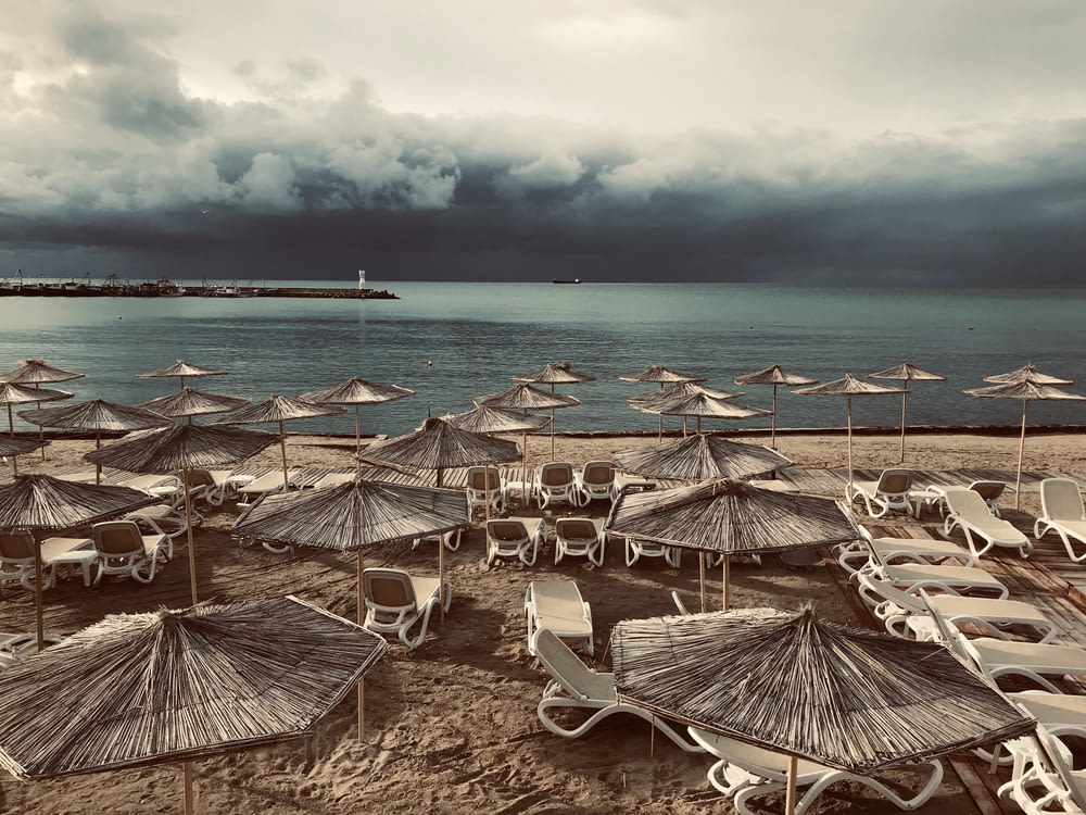 a bunch of chairs and umbrellas on a beach