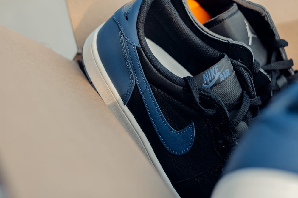a close up of a pair of blue and black sneakers