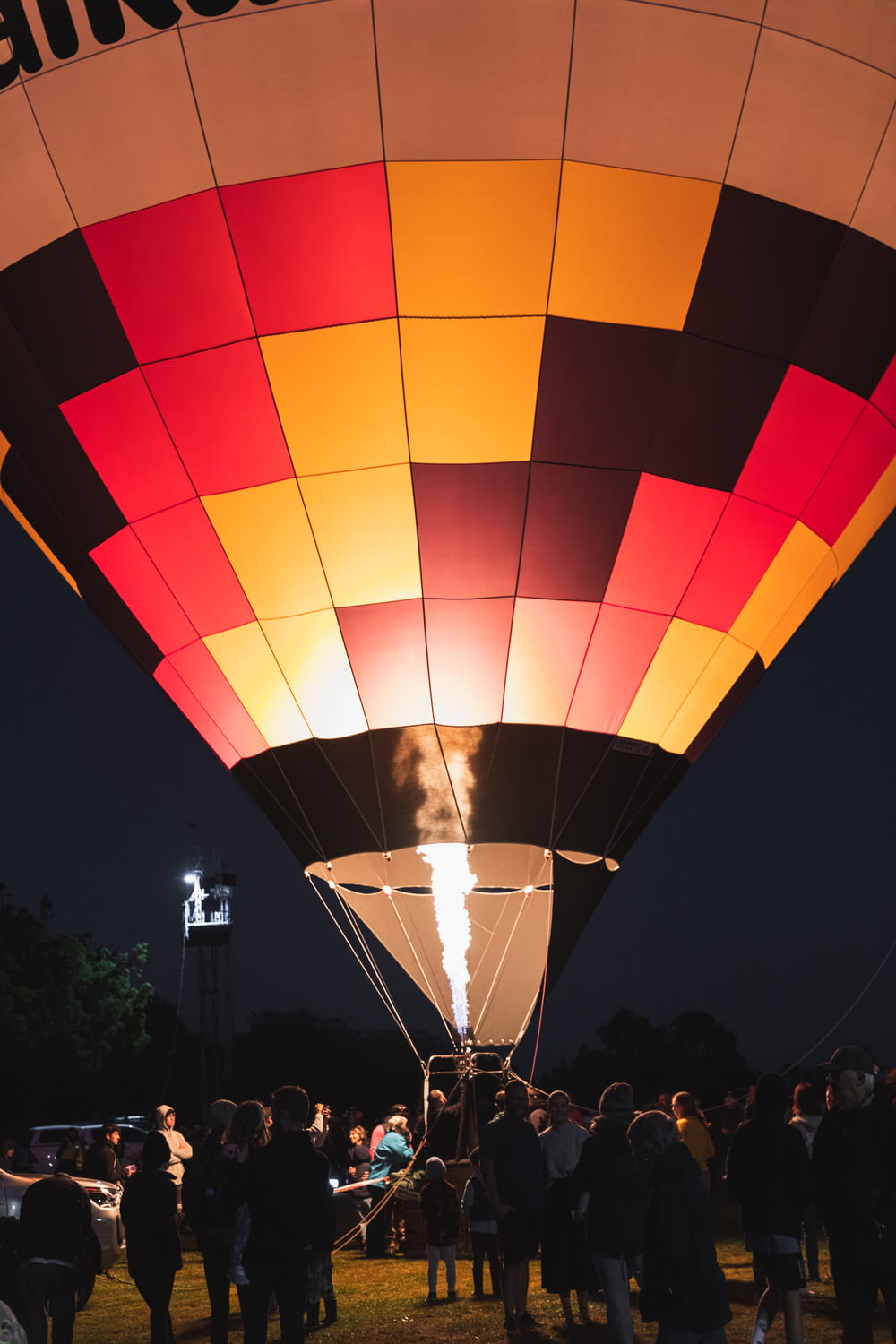 a group of people standing around a hot air balloon