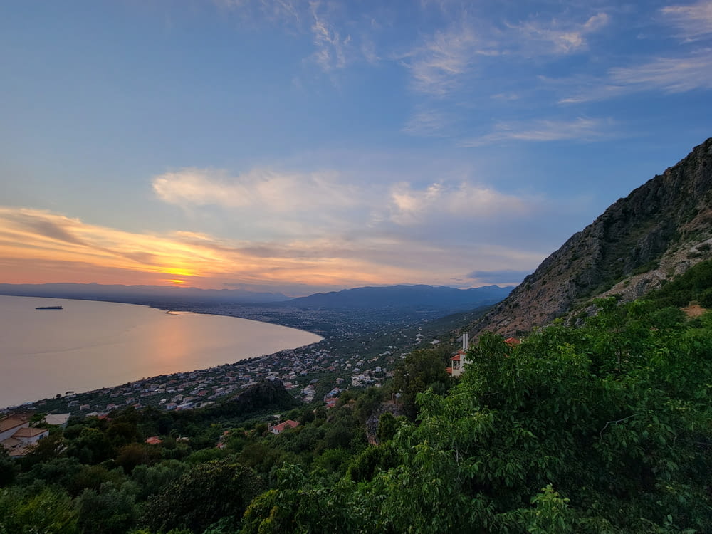 a scenic view of a lake and mountains at sunset