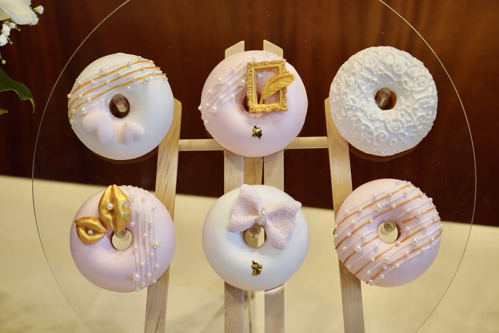 a glass plate topped with donuts covered in frosting