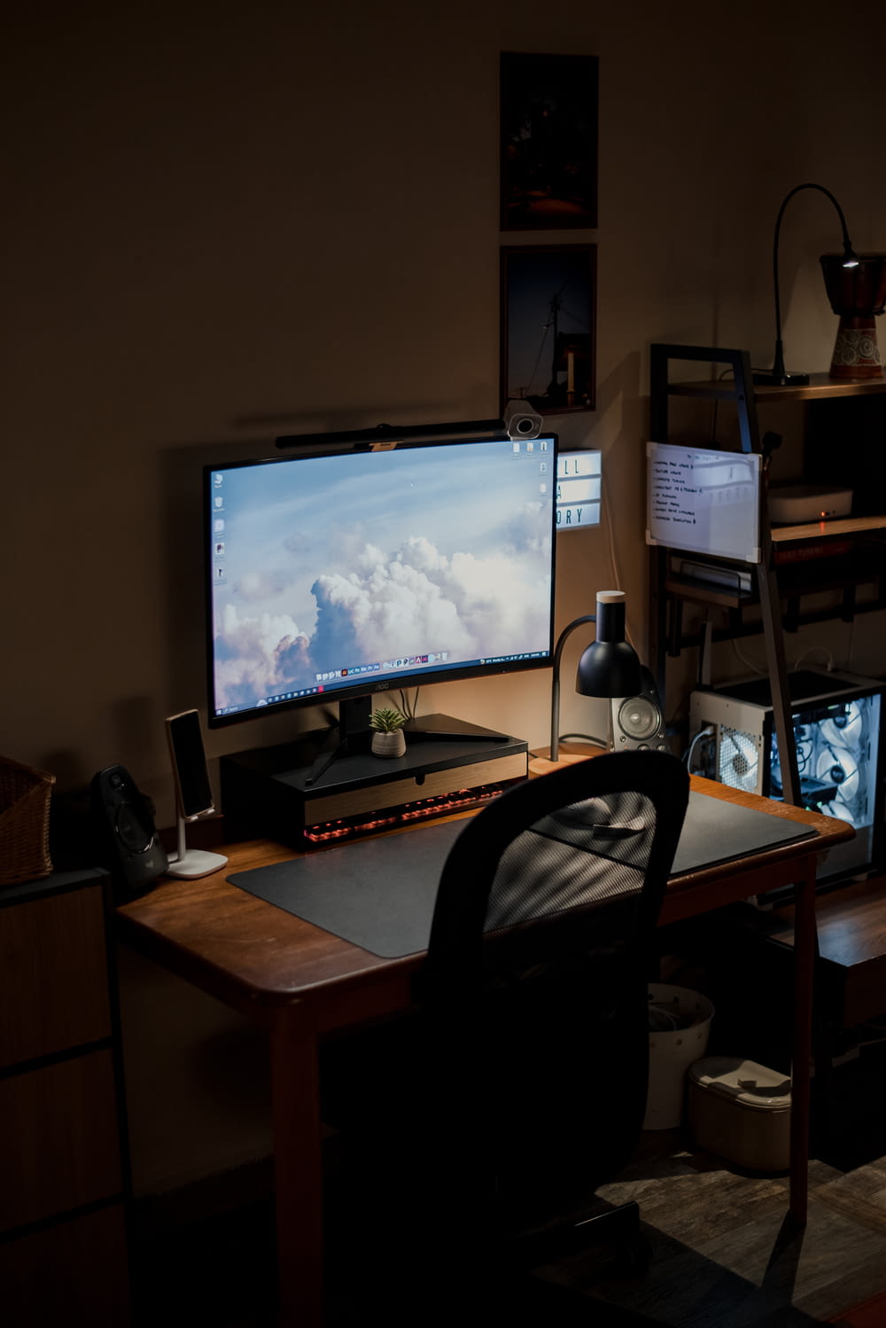 a desk with two monitors and a keyboard