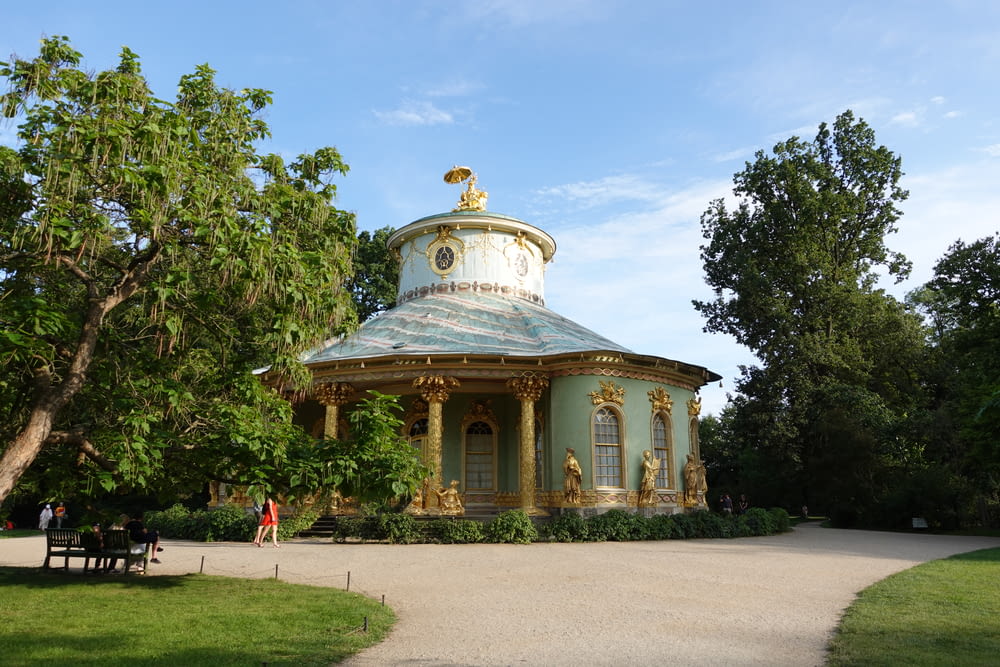 a gazebo in the middle of a park surrounded by trees