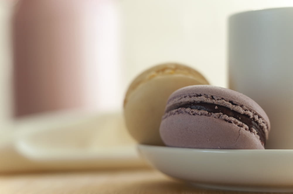 a plate of macaroons and a cup of coffee
