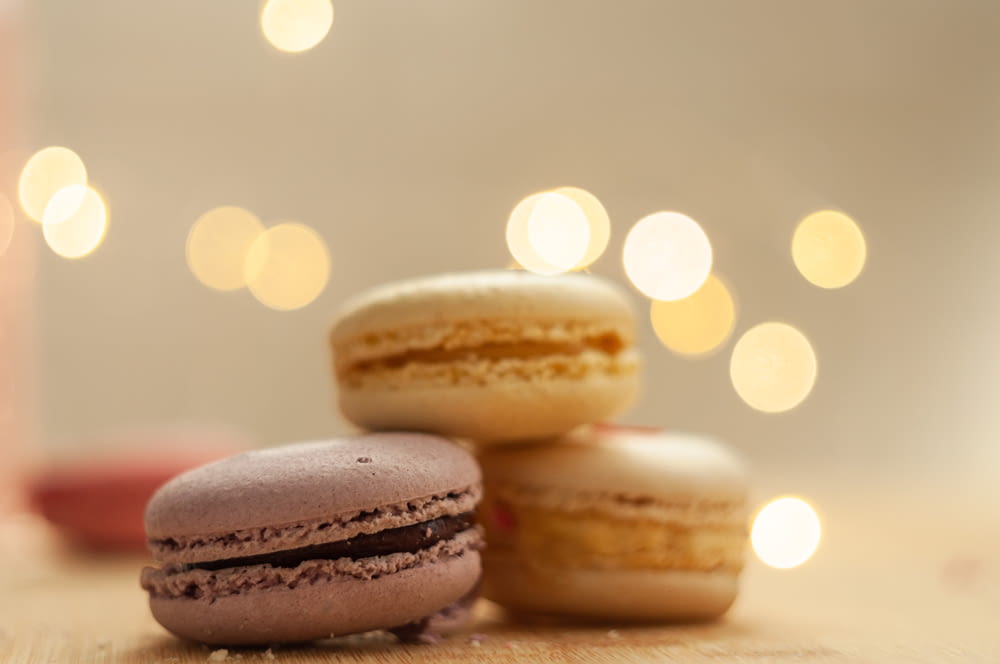 a close up of three macaroons on a table