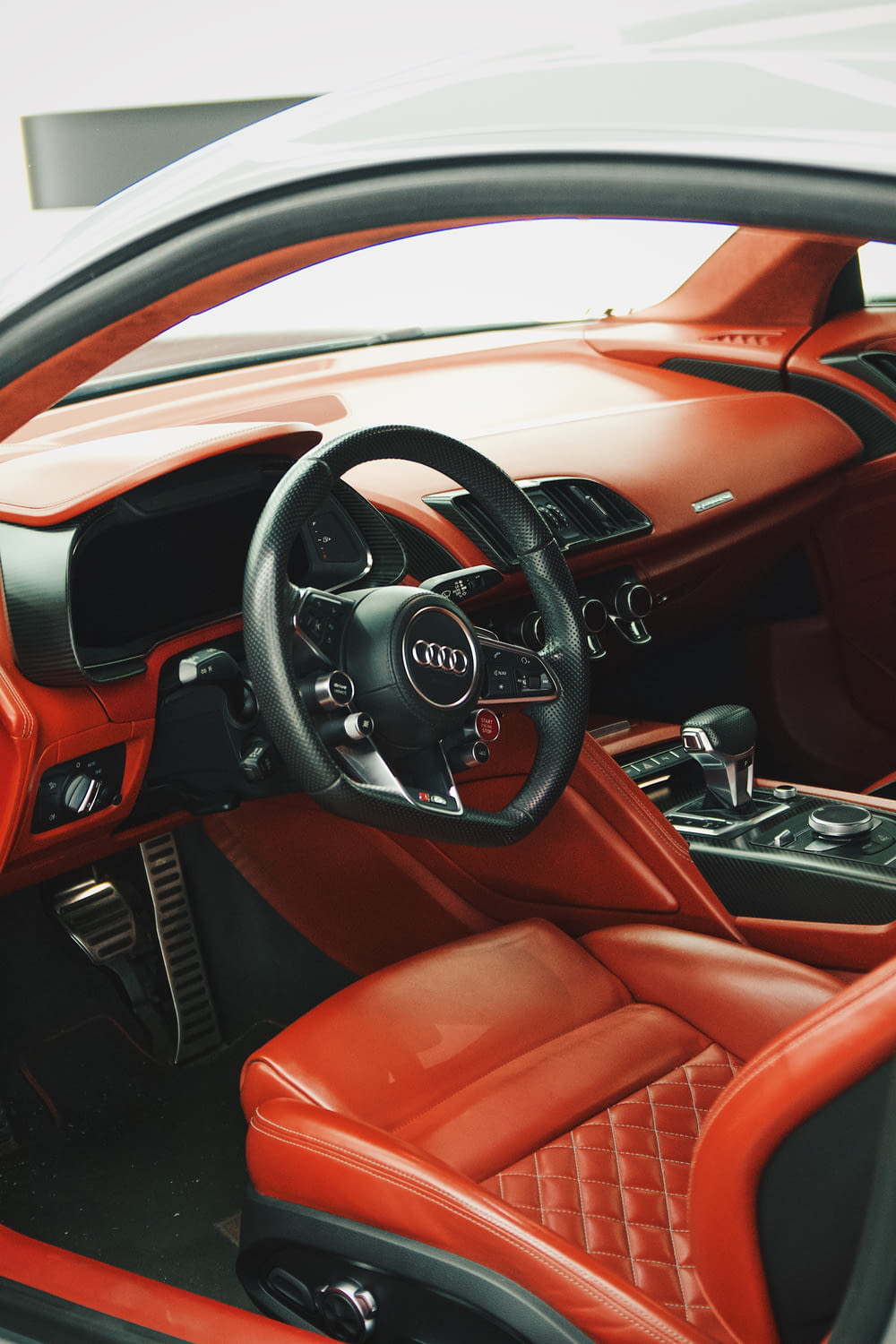the interior of an orange and black sports car
