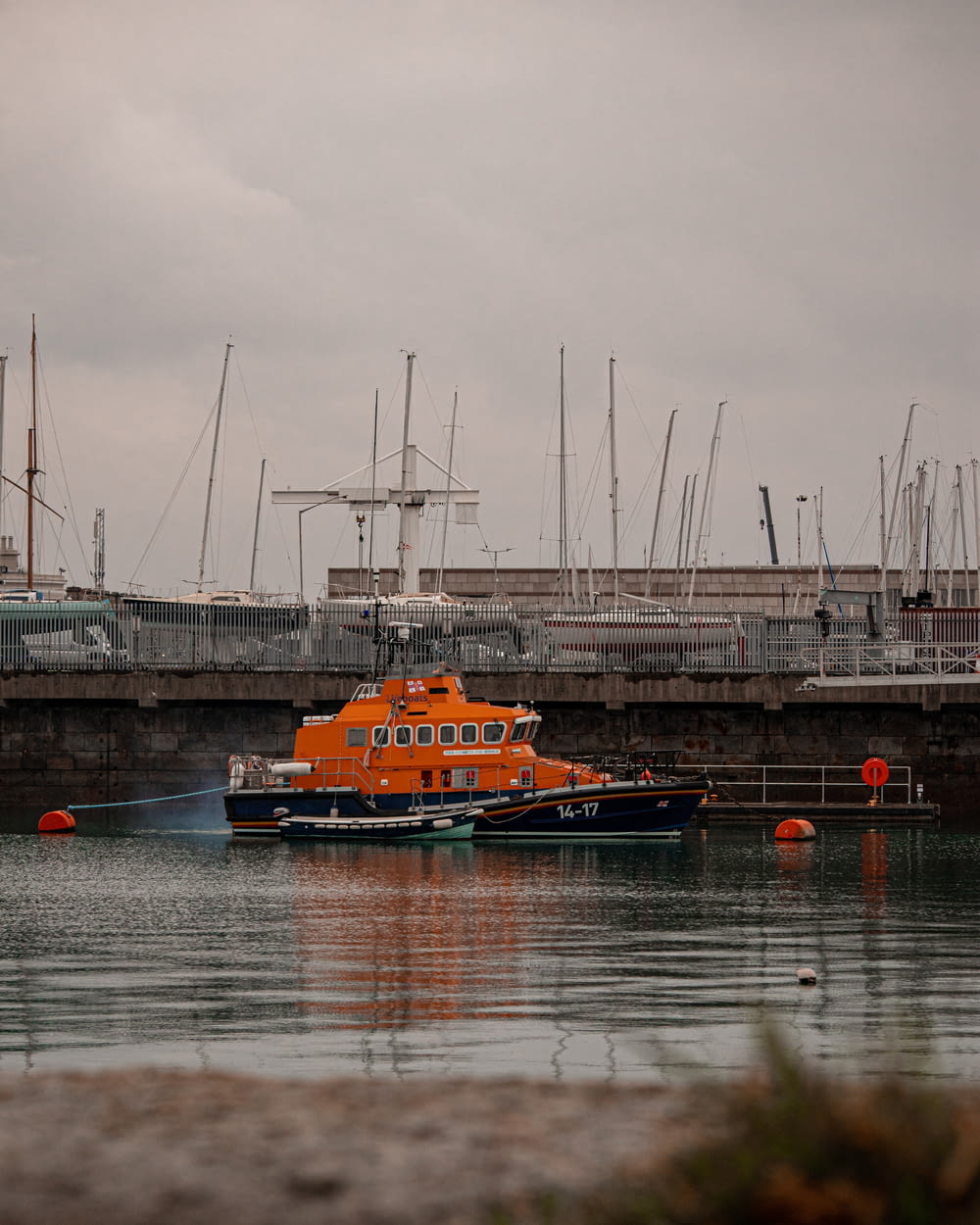 a large orange boat floating on top of a body of water