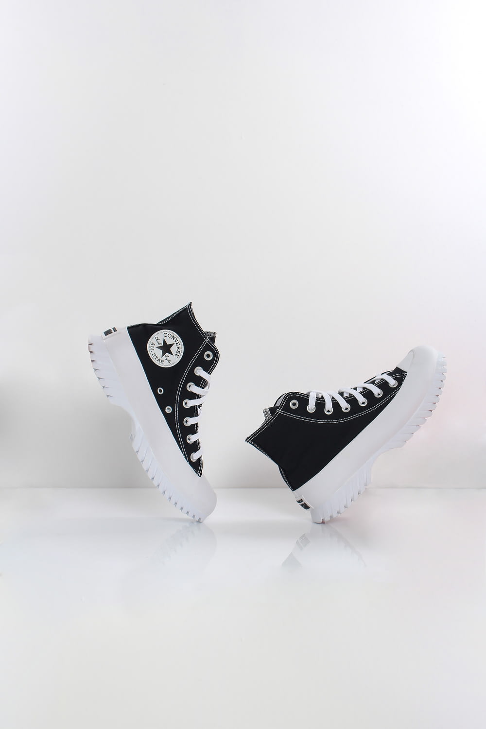 a pair of black and white converse sneakers