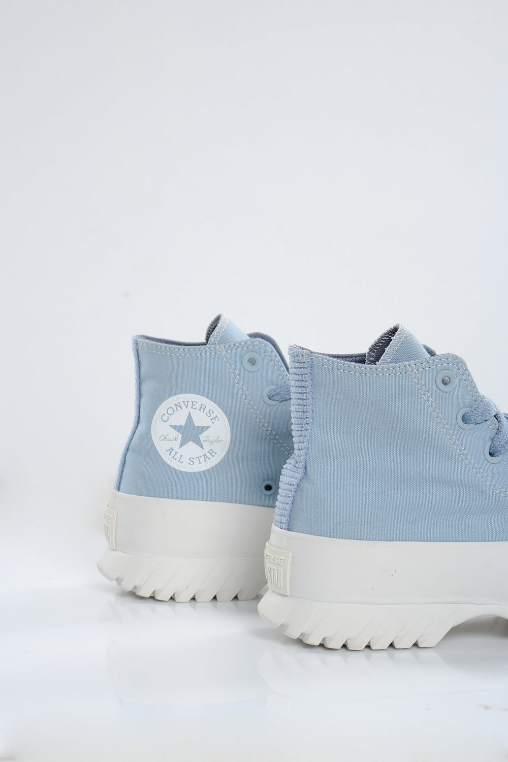 a pair of blue converse sneakers on a white background