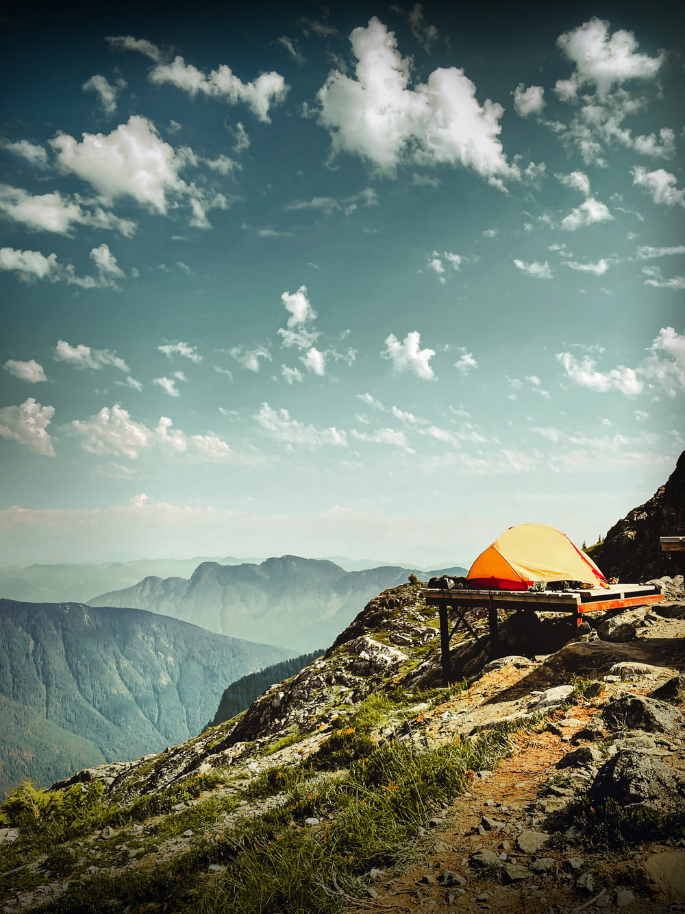 a tent set up on top of a mountain