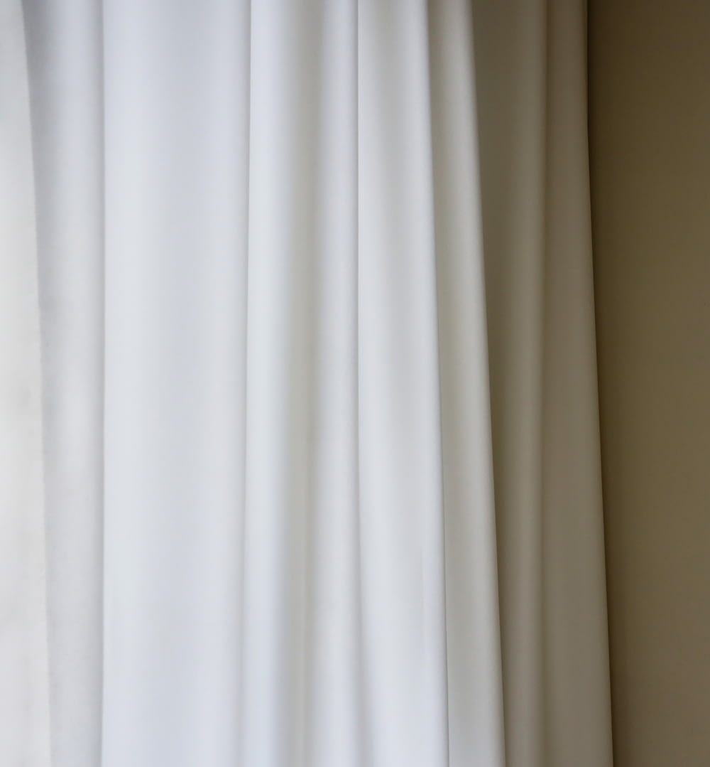 a close up of a white curtain in a room
