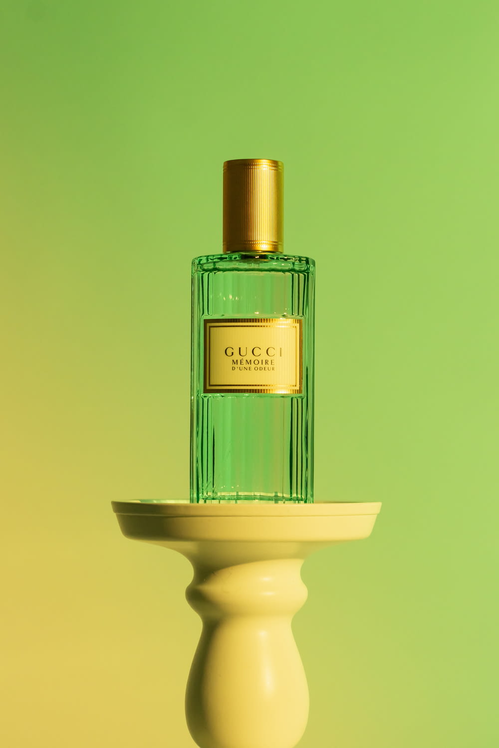a bottle of perfume sitting on top of a pedestal