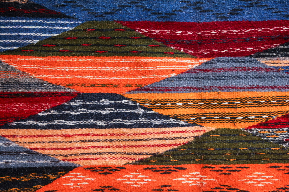 a close up of a colorful rug with many different colors