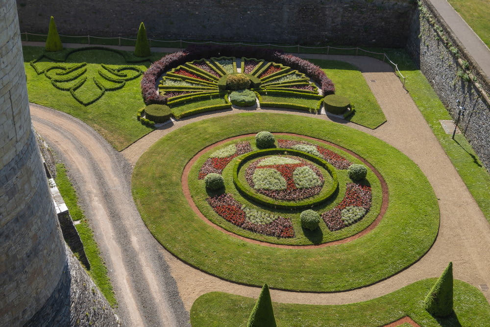 an aerial view of a circular garden in a castle