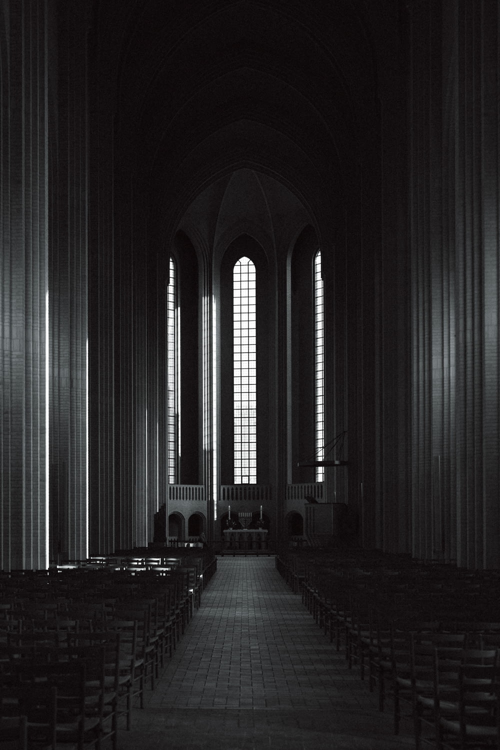 an empty church with rows of pews