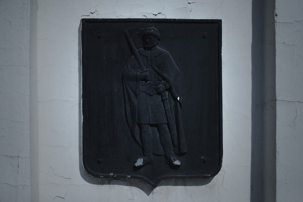 a plaque of a soldier on a white wall