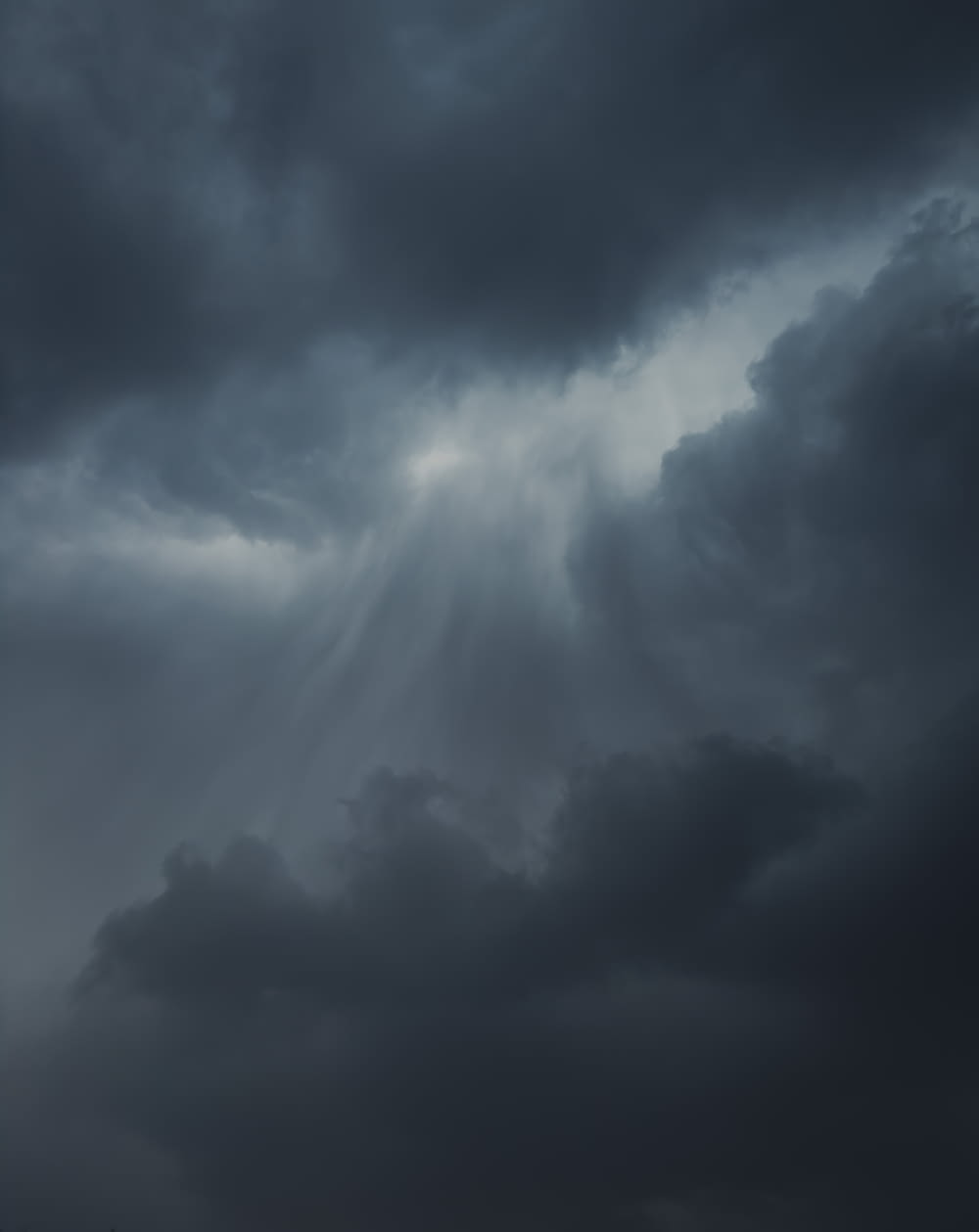 a plane flying through a dark cloudy sky