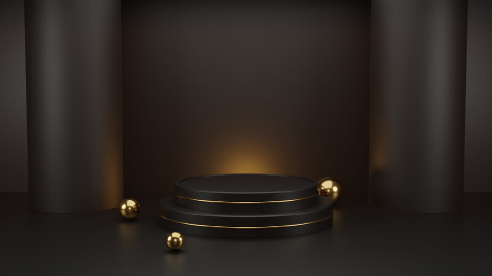 黒い背景に金のボールを持つ黒い表彰台