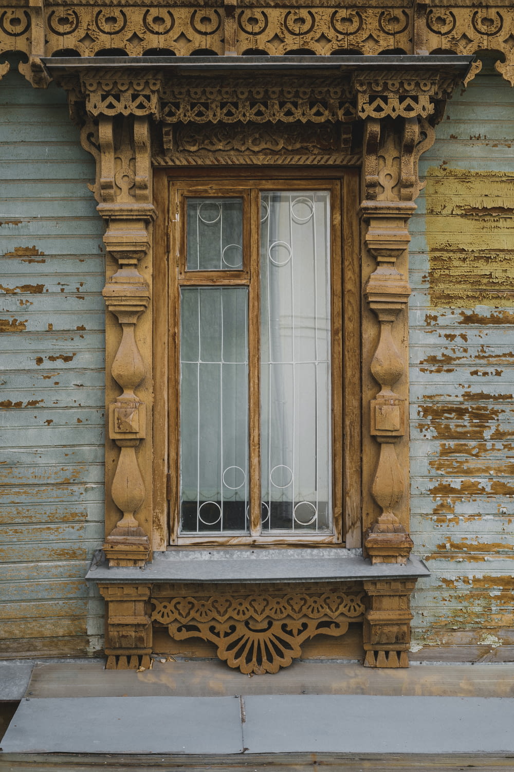 a wooden window on the side of a building