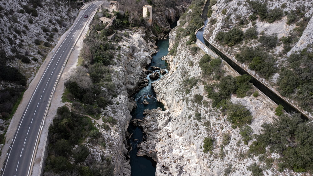 an aerial view of a road and a river