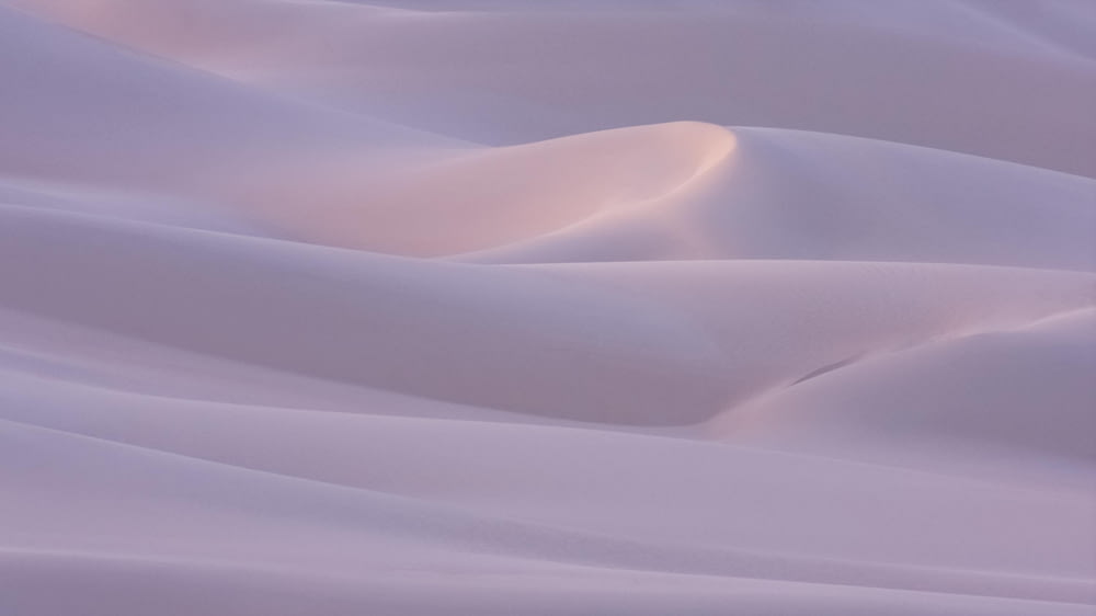 a group of white sand dunes in the desert