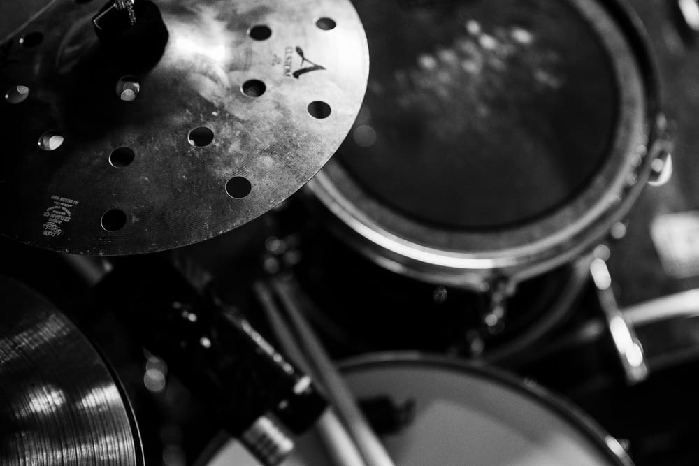 a black and white photo of a drum set