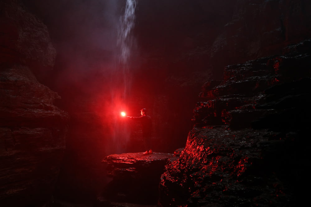 a red light shines in a dark cave