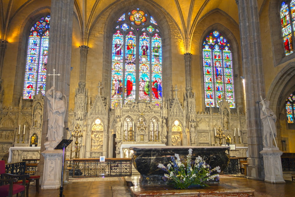 a large cathedral with stained glass windows and pews