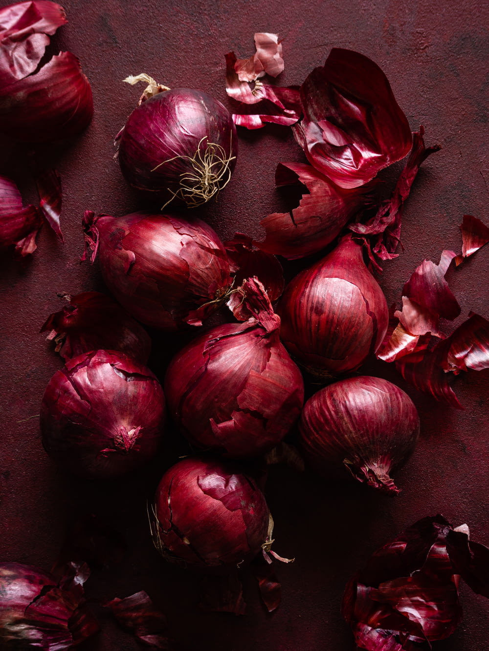 a pile of red onions sitting on top of a table