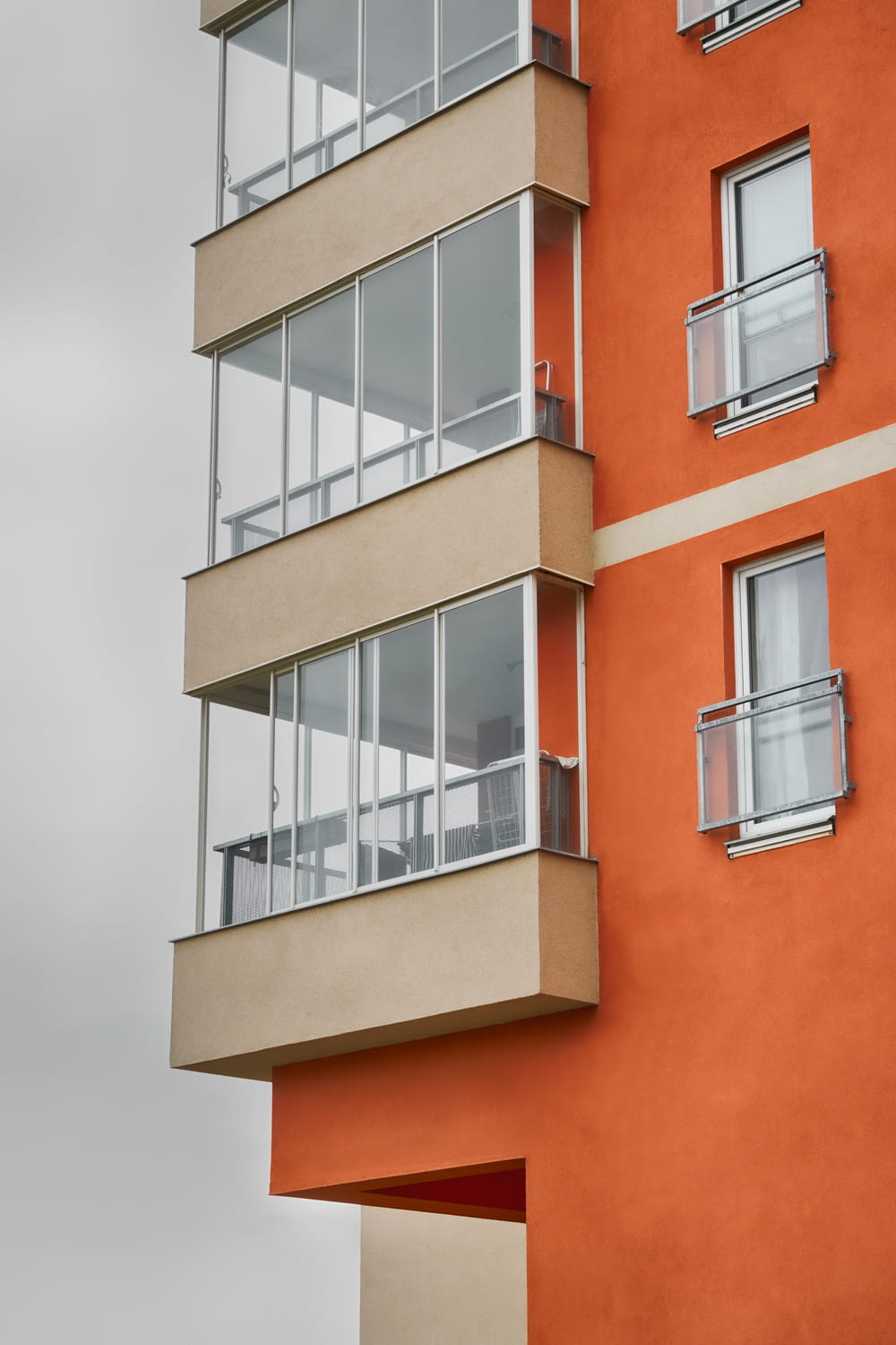 Ein hohes orangefarbenes Gebäude mit Balkonen und Fenstern