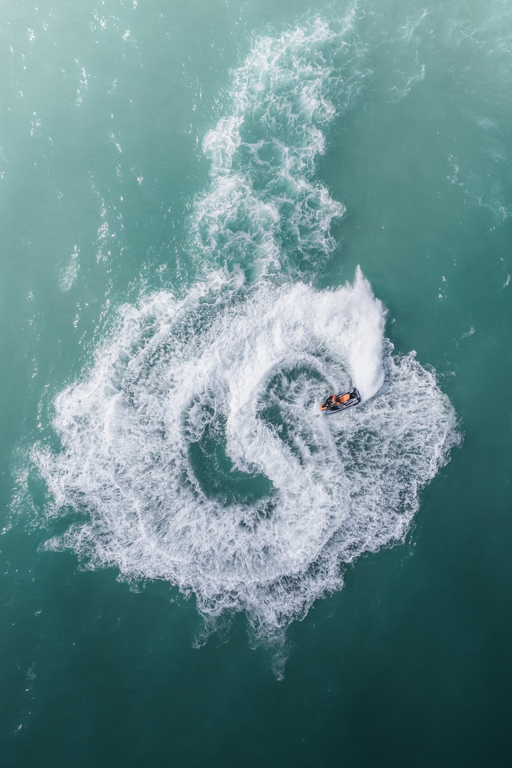 a person on a surfboard riding a wave in the ocean