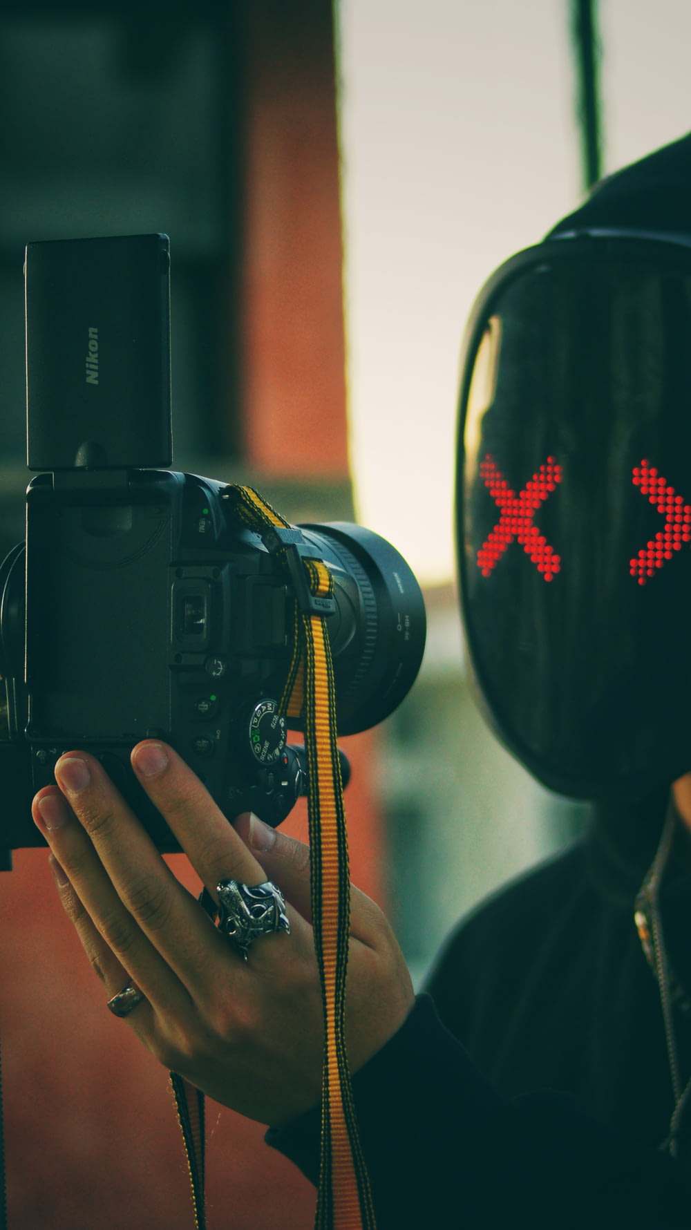 a person wearing a mask and holding a camera