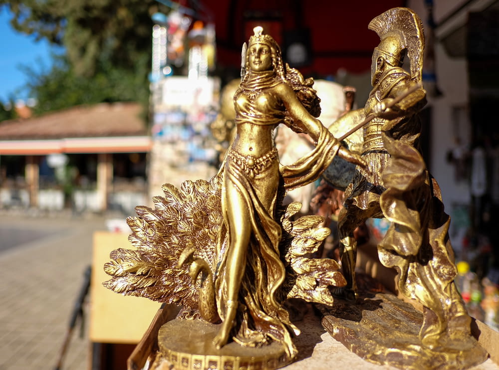 a gold statue of two women holding hands