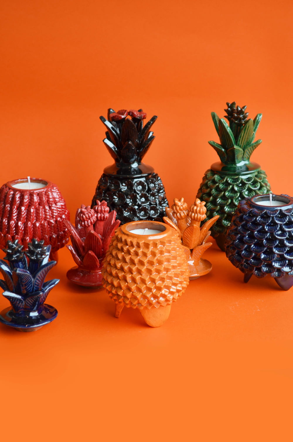 a group of ceramic pineapples sitting next to each other