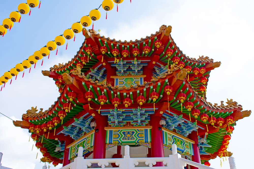a chinese building with decorations hanging from it's roof