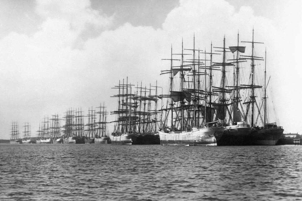 a black and white photo of a fleet of ships