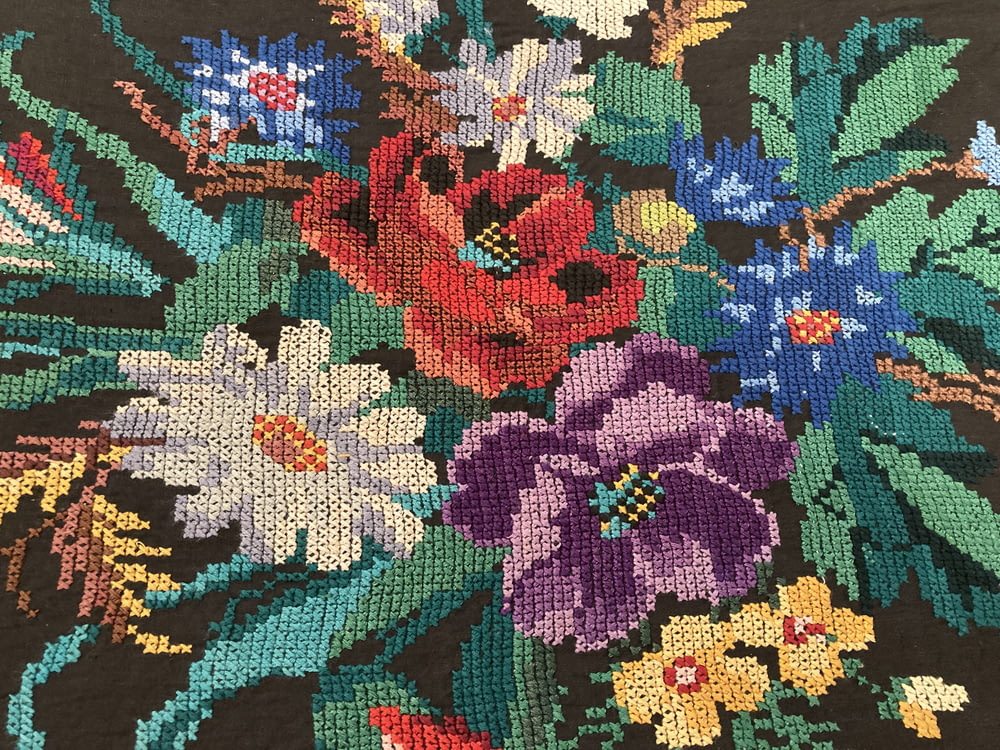a cross stitch picture of a bouquet of flowers