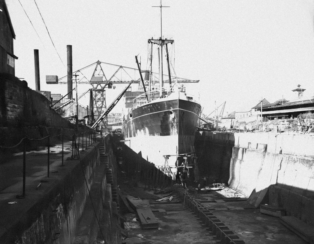 a black and white photo of a boat in a dry dock