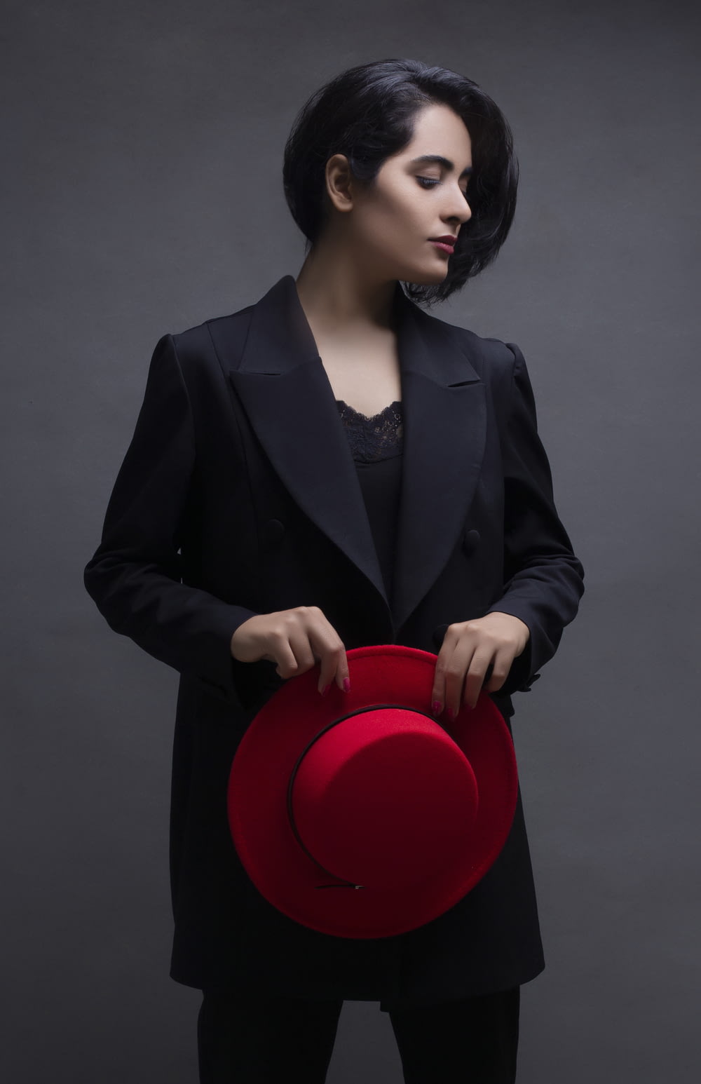 a woman holding a red hat in her hands