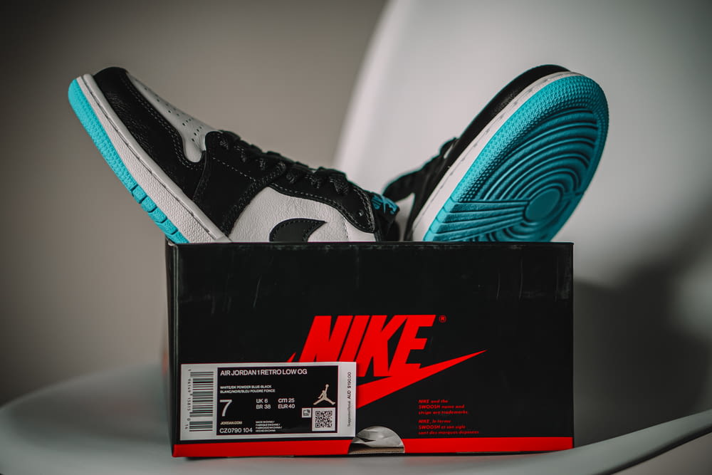 a pair of sneakers sitting on top of a box