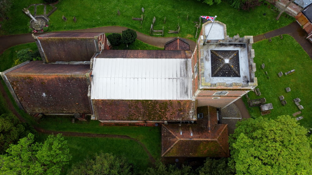 an aerial view of an old building in the middle of a forest
