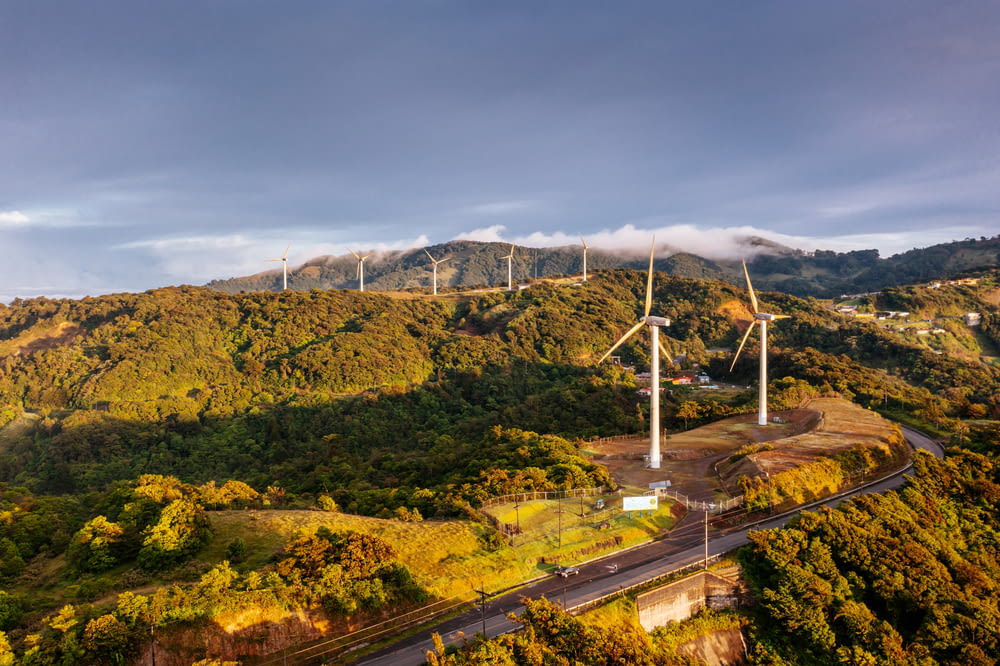 an aerial view of a wind farm in the mountains