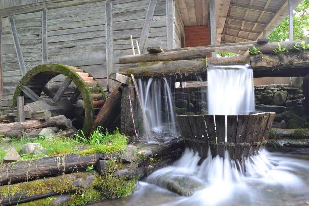 a water mill with a waterfall coming out of it
