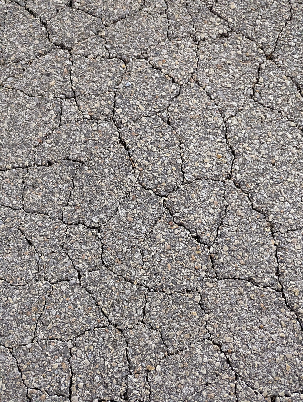 a close up of a cracked asphalt surface