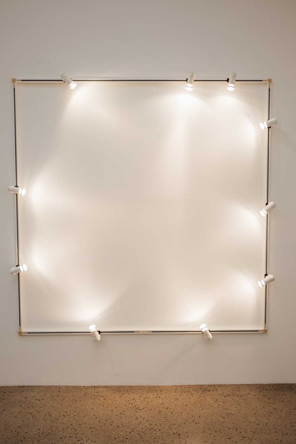 a white wall with some lights on it