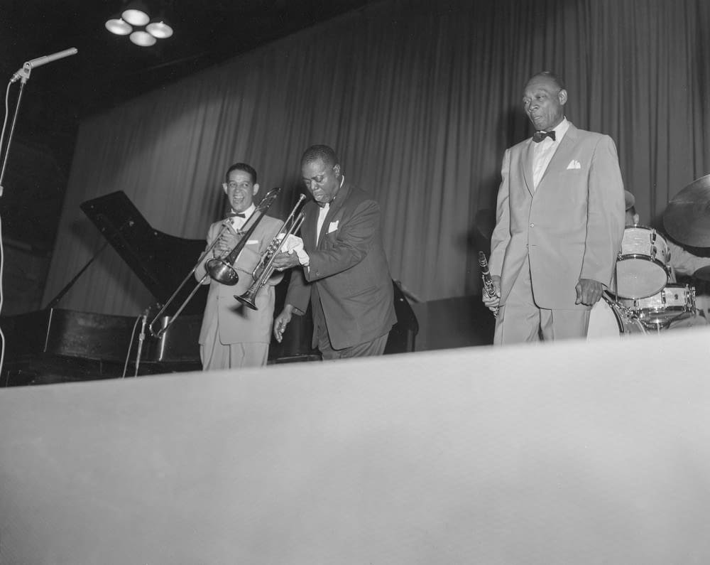 a group of men standing next to each other in front of a microphone