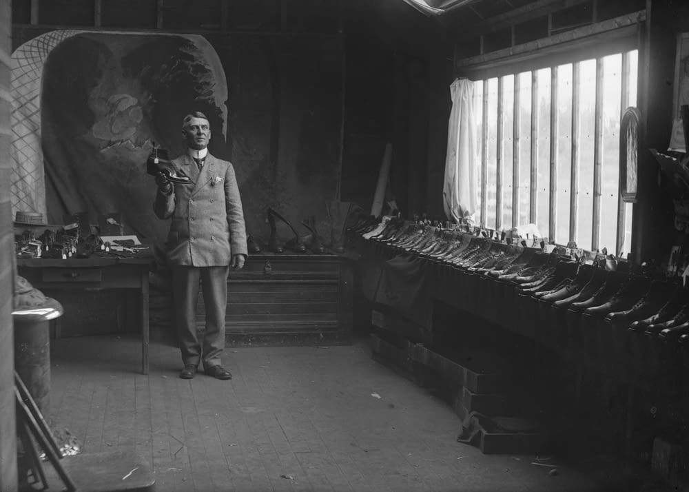 a man standing in a room with lots of tools