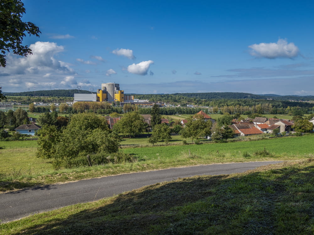 a view of a rural area with a large factory in the distance