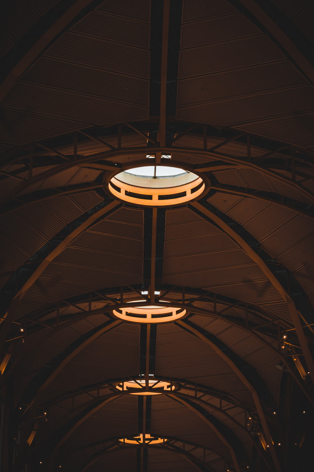 a train station with lights hanging from the ceiling