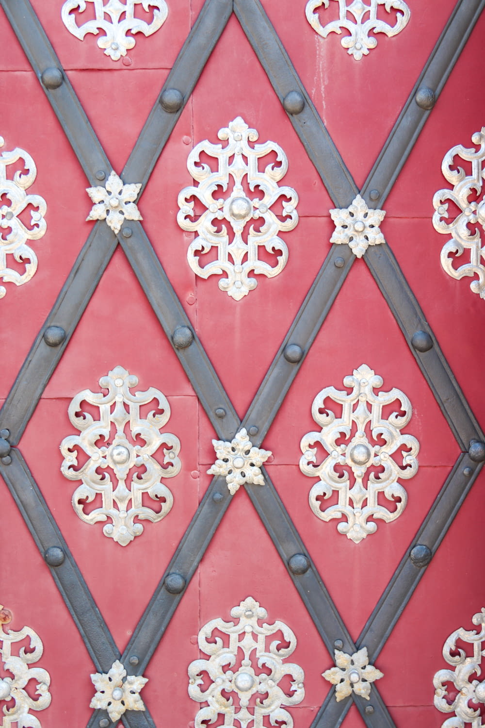 a close up of a red wall with a pattern on it